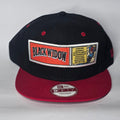 New Era black and red snapback cap with Black Widow patch and Marvel logo.