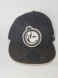 New Era black and white snapback cap with YUMS embroidered patch and cotton material.